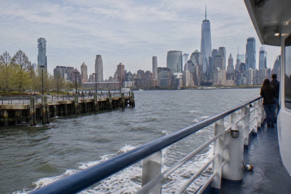 Open deck of a sightseeing boat with the Manhattan skyline across the water