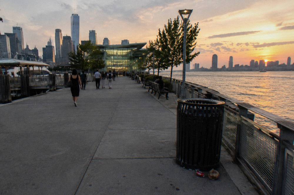 A wide Hudson River walkway in Midtown with piers on the left and the river on the right