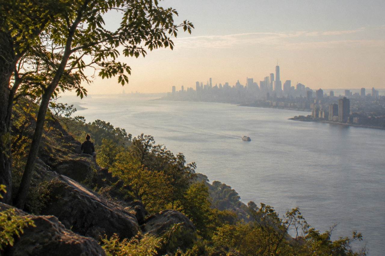 Wide view of the Hudson River with the Manhattan skyline rising above the water