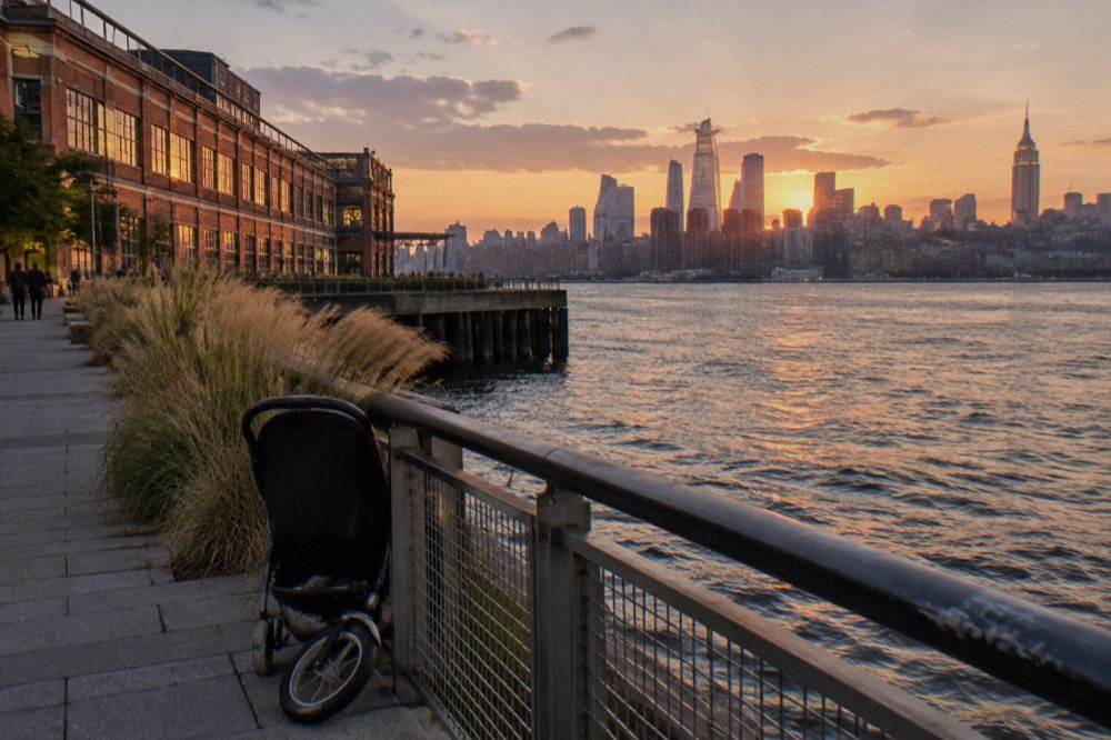 A waterfront walkway near a Manhattan cruise pier with the skyline rising behind it
