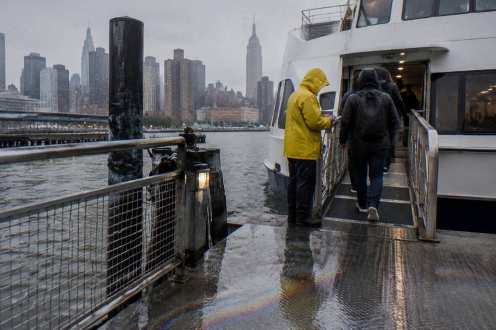 A crew member checking tickets at the gangway of a sightseeing boat