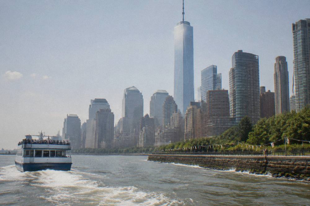 A classic sightseeing cruise boat passing the Manhattan waterfront at midday