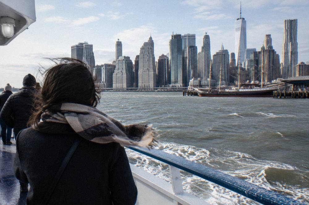 Lower Manhattan skyscrapers seen across the water from a boat deck