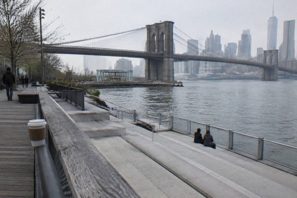 The Brooklyn Bridge and Lower Manhattan skyline seen from the East River waterfront