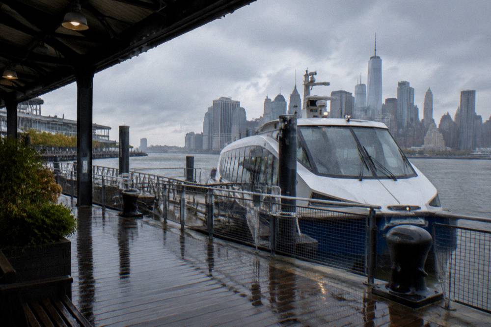 Rain clouds over the Manhattan skyline seen from the harbor water